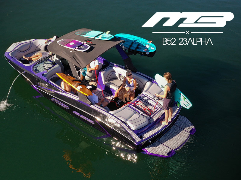 black and purple MB B52 23ALPHA boat with man getting ready to surf
