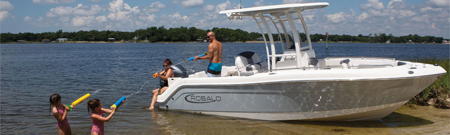 A family enjoying the lake with a 2021 Robalo Boat.